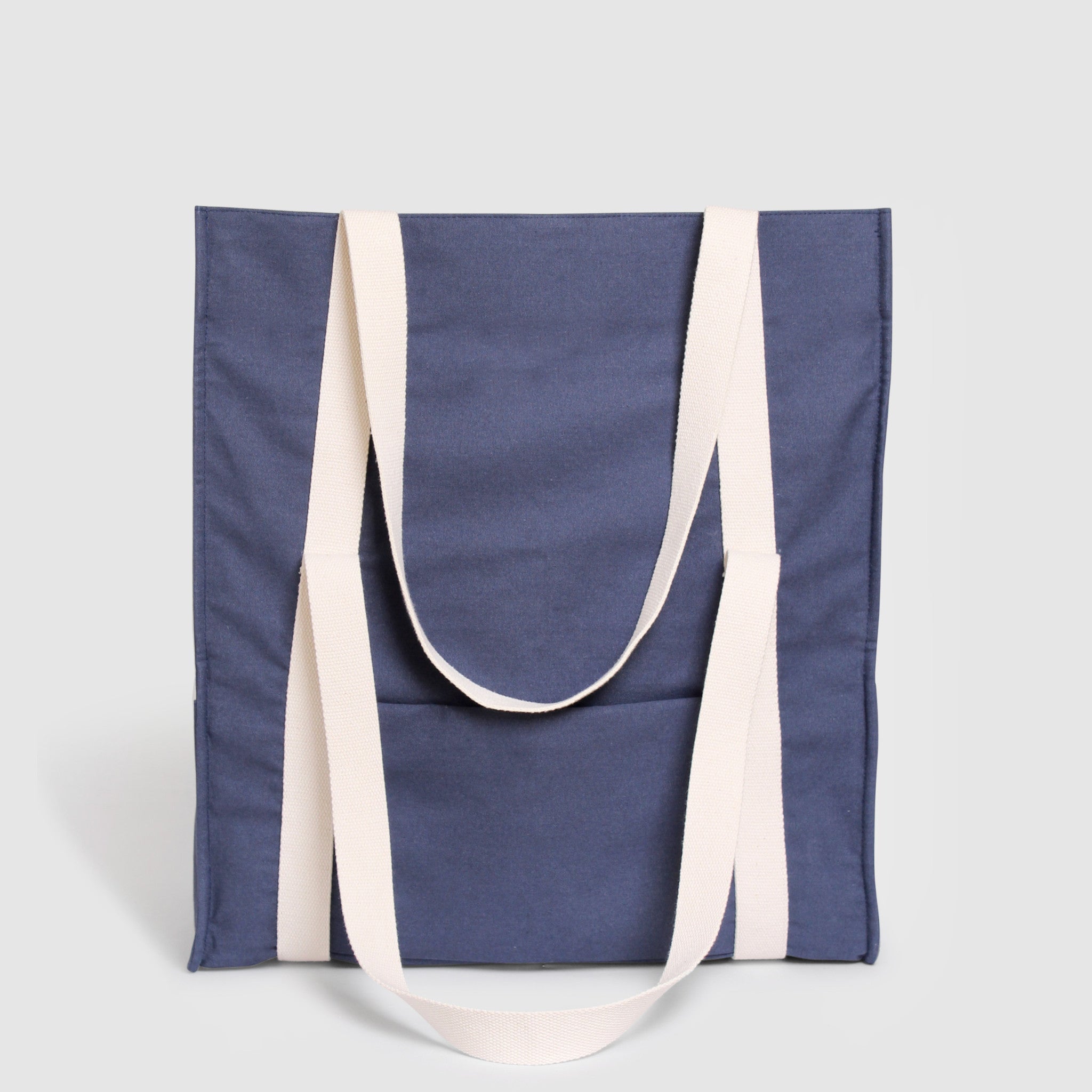 Blue canvas travel bag with white straps, expandable from 25 to 45 cm, exterior zip pocket, trolley sleeve, and organized interior with laptop compartment, secure passport storage and outside pocket for water quick access