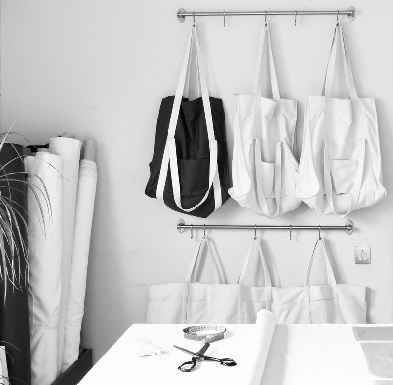 photo of our atelier in portugal with tote bags on display