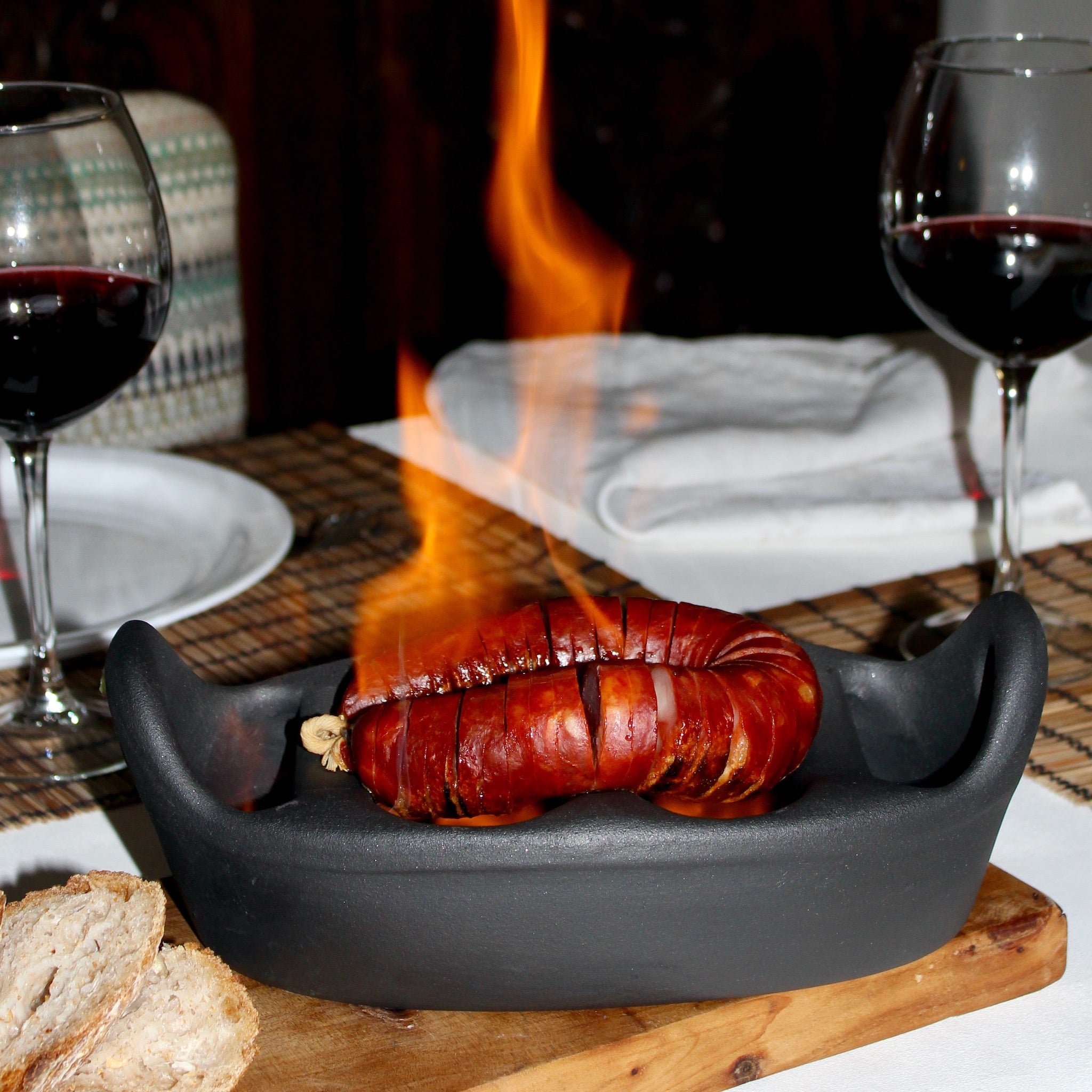 Handcrafted Portuguese clay chouriço grill — traditional black terracotta sausage roaster made from natural clay, perfect for open flame cooking