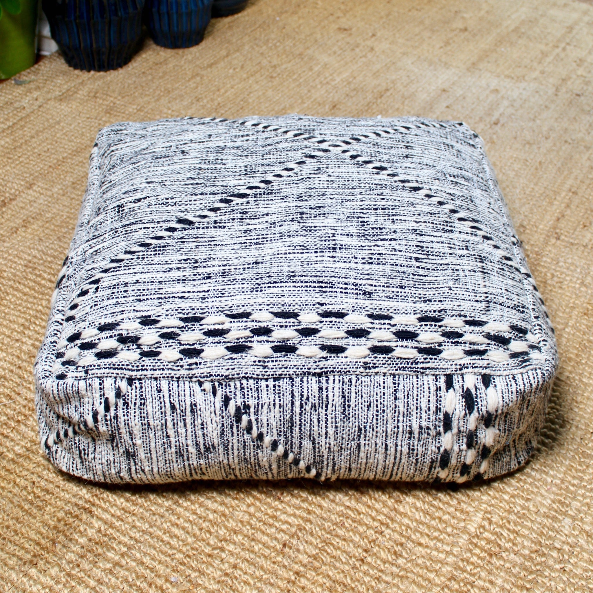 Black and beige Moroccan wool pouf with handcrafted Berber patterns, 60×60×20 cm artisan floor cushion with traditional geometric design