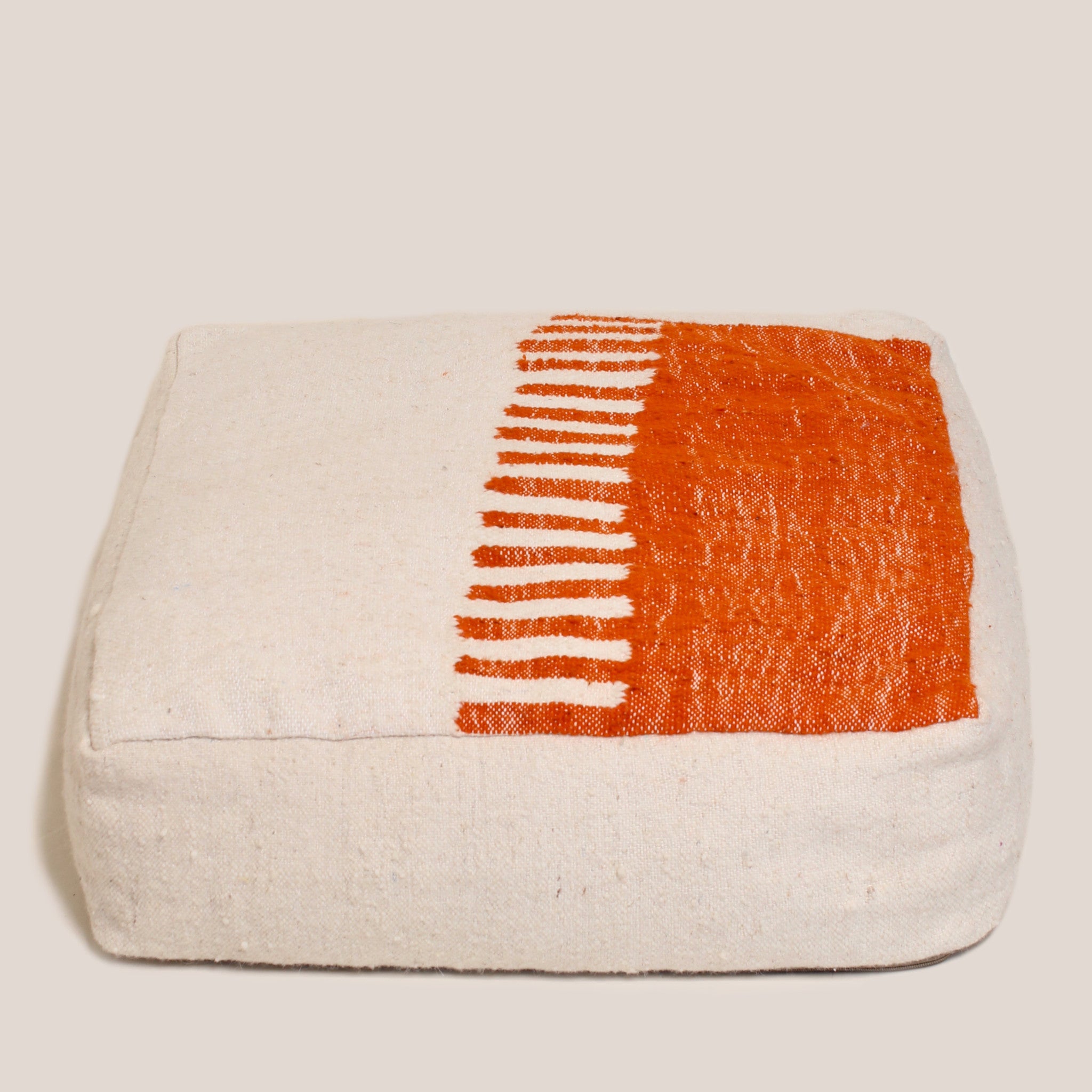Half beige and half orange Moroccan wool pouf with geometric Berber pattern, 60×60×20 cm, handmade and artisan-crafted floor cushion