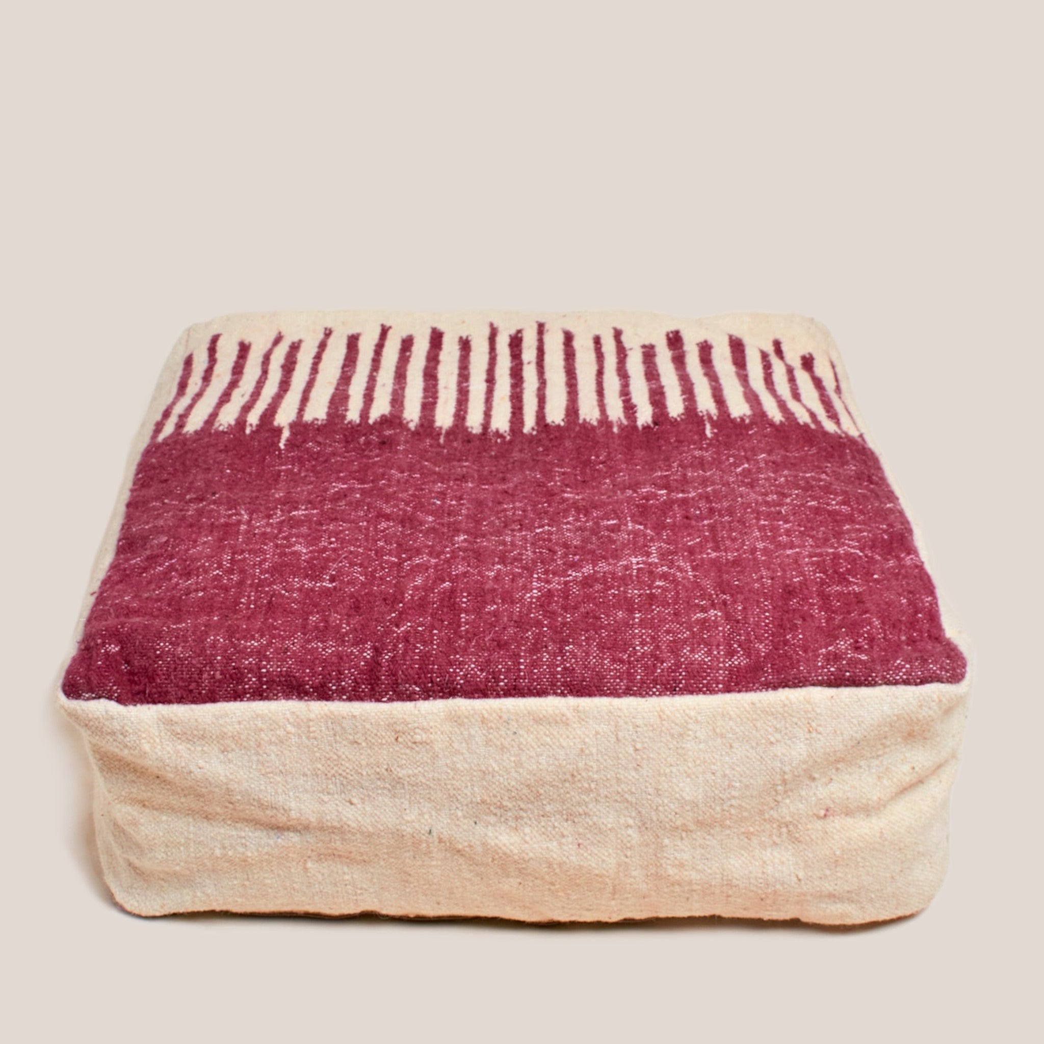 Half beige and half bordeaux red Moroccan wool pouf with geometric Berber design, 60×60×20 cm, handcrafted and artisan-finished floor pillow