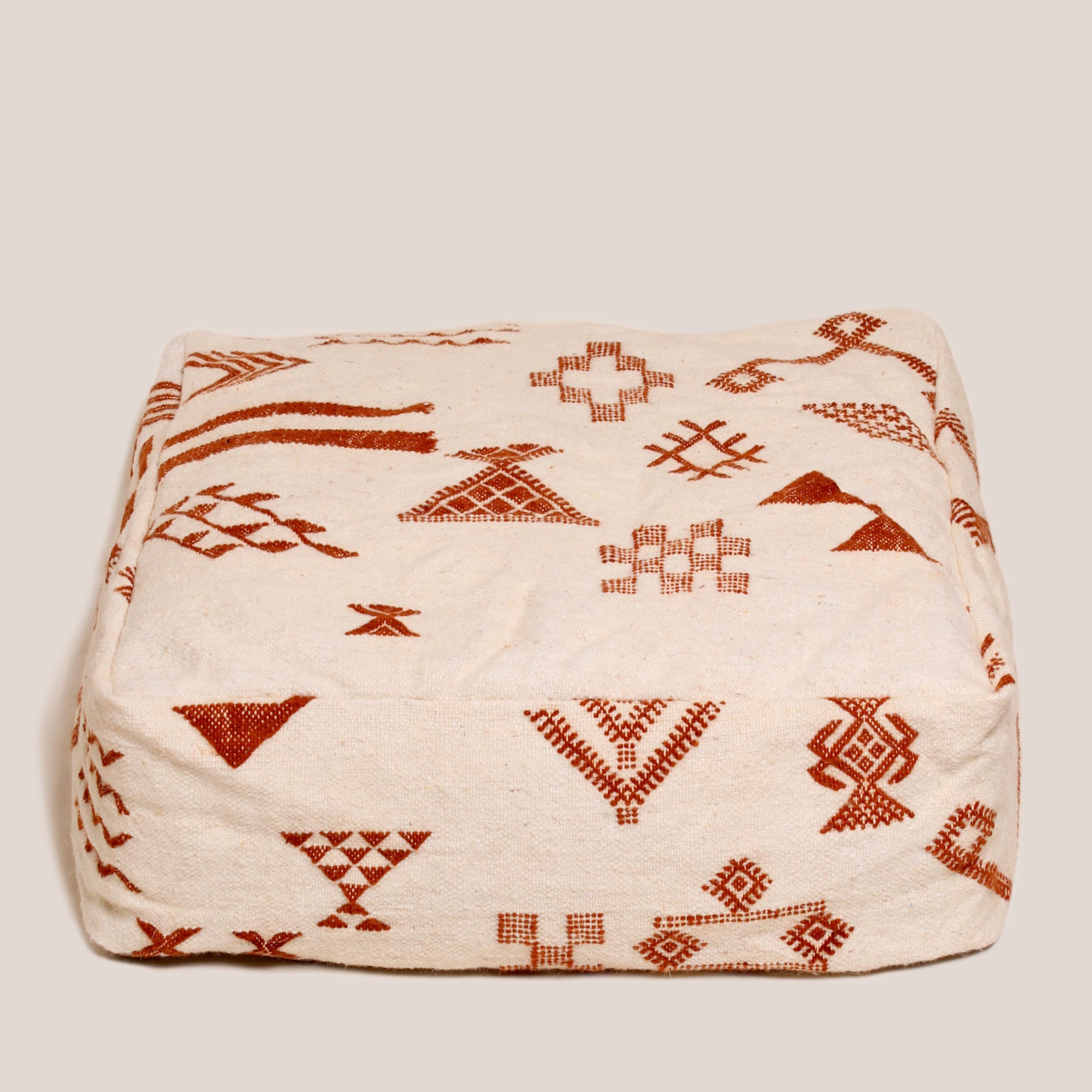 Beige Moroccan wool pouf with brown Berber geometric patterns, 60×60×20 cm, handcrafted artisan floor cushion