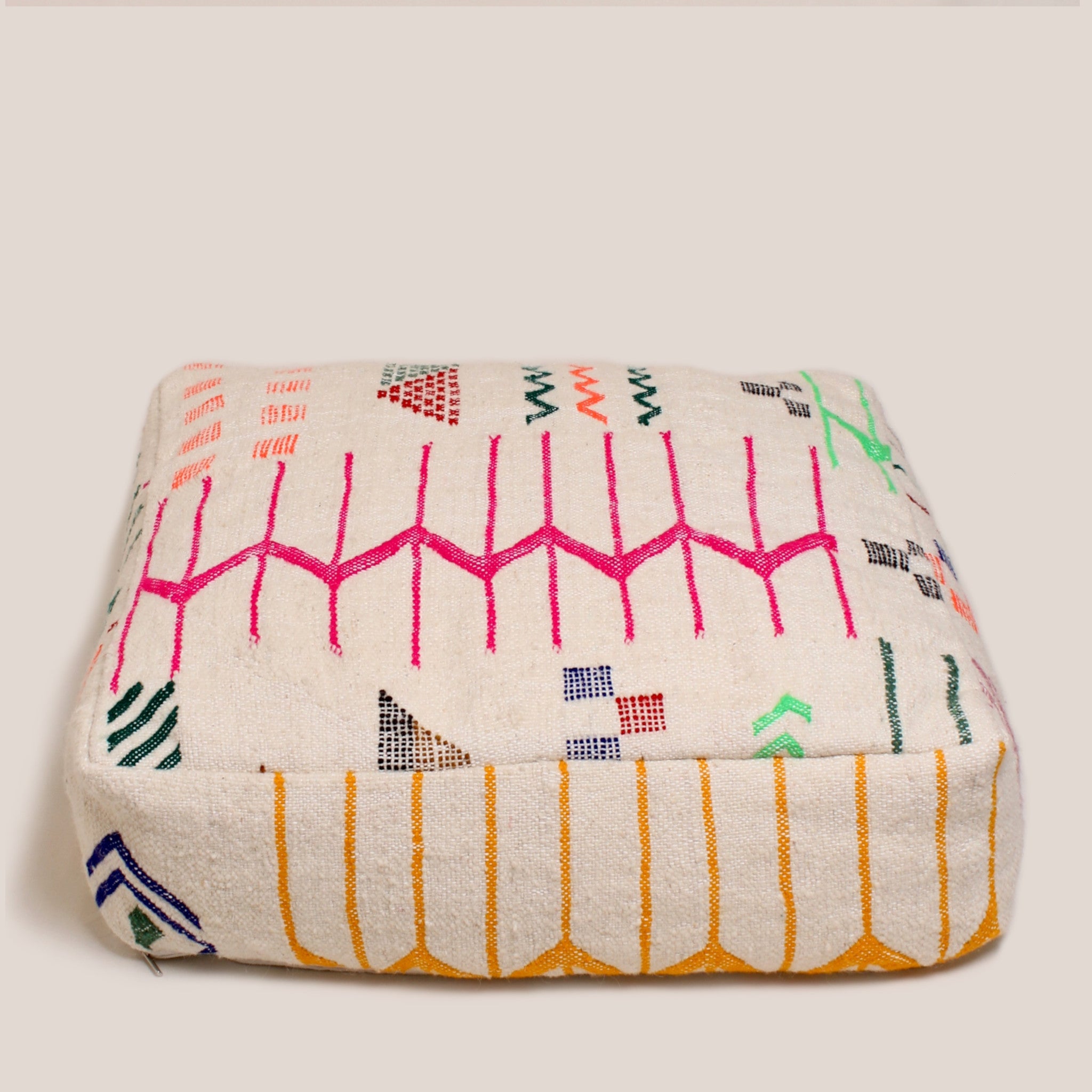 Beige Moroccan pouf handmade from Azilal rug with multicolor tribal patterns, 60×60×20 cm wool cushion, crafted in the Atlas Mountains