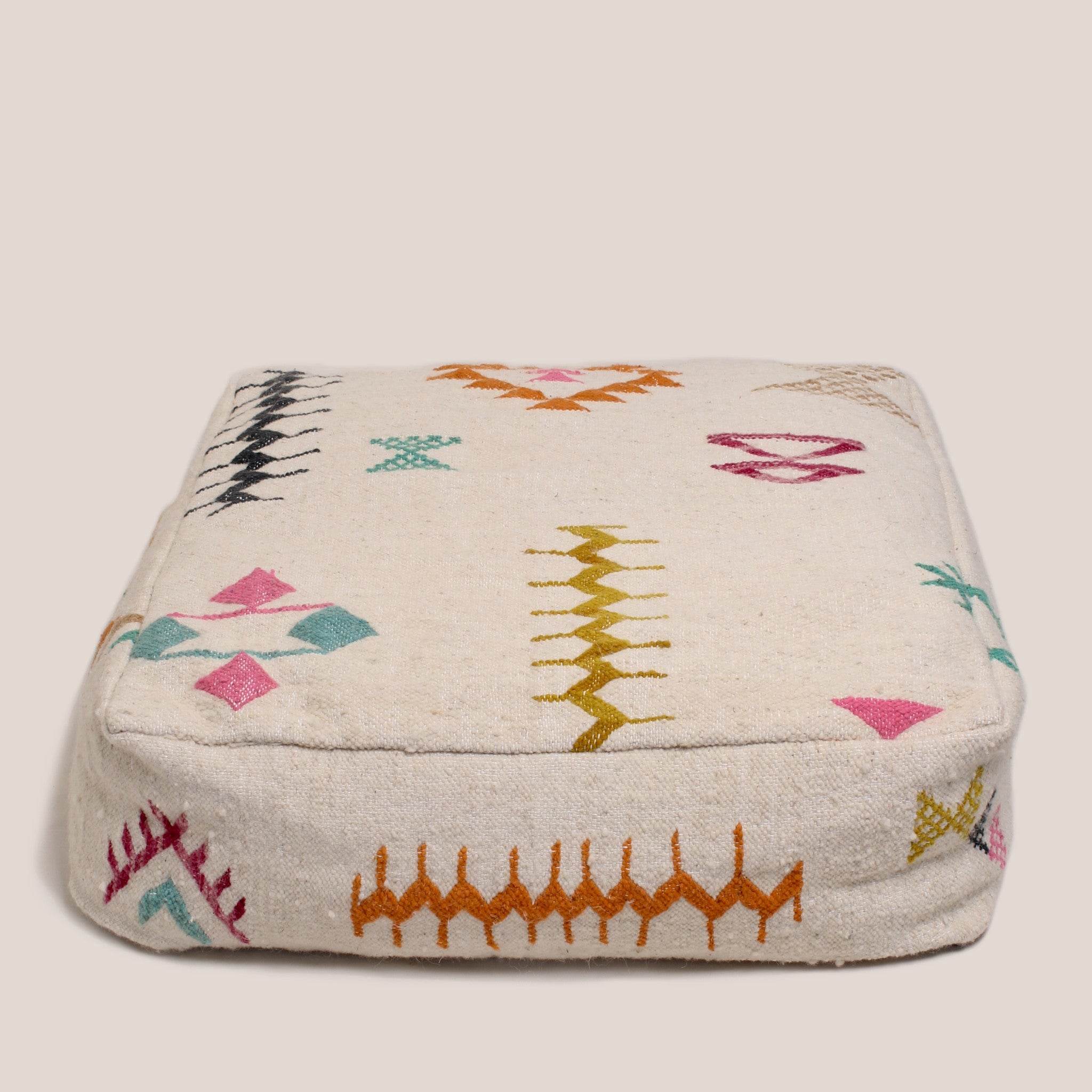 Beige Moroccan wool pouf with multicolor Azilal Berber patterns, 60×60×20 cm, handcrafted artisan floor cushion